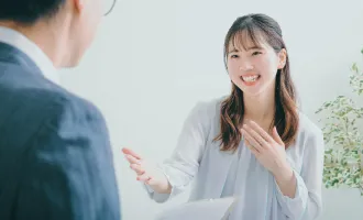 女性が眼鏡をかけた男性にインタビューをしている画像